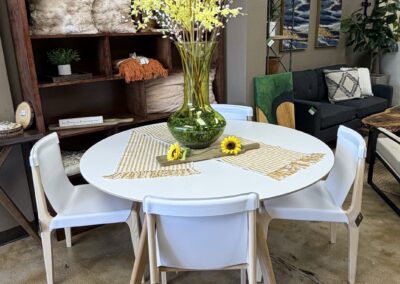 white round table with four white chairs image
