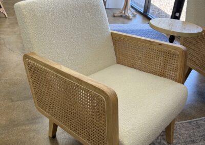 small accent chair with white upholstery and side canning image