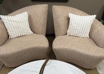 Beige asymetric pair of swivel chairs image