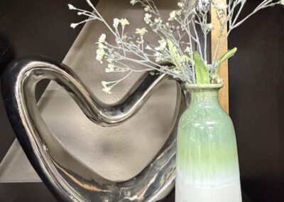 Stylized heart sculpture with green and white glazed ceramic vase image