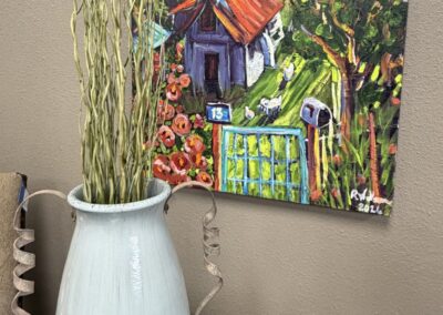 Green glazed ceramic vase with twisty metal handles and hand painted picture of a church image
