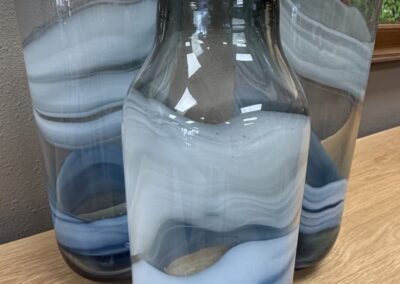 three blue glass vases with swirl design image