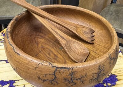 wooden serving bowl with serving utensils image