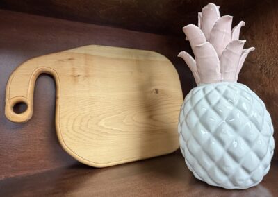 cutting board paired with a ceramic pineapple image