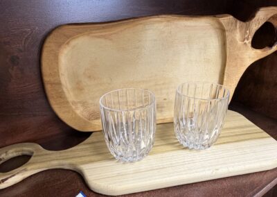 Two wood cutting boards paired with two crystal lowball glasses image