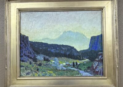 Gold framed landscape painting in blues image