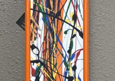 narrow paint splatter on canvas in orange metal frame image