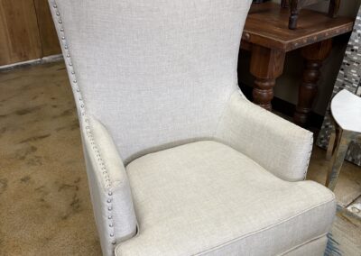 Contemporary wingback chair with metal stud detailing